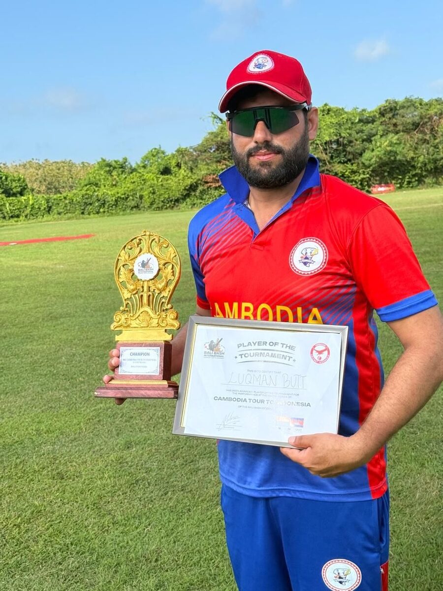 Luqman Butt holding a trophy and his Player of the Tournament certificate